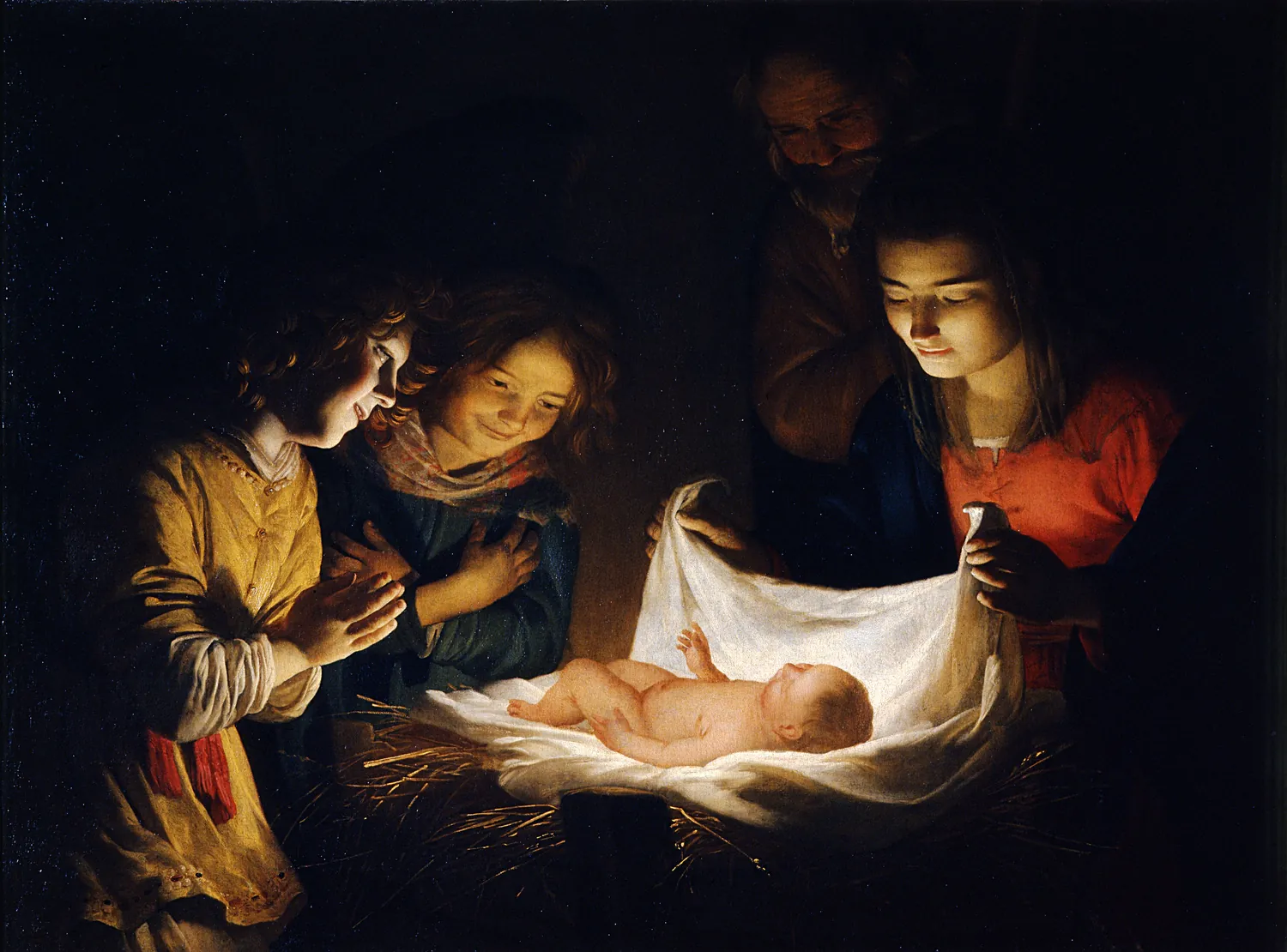 A newborn lies on straw. His own light shines up on the faces of a woman and two young people who lean over him with their hands together. A man looks on from behind.